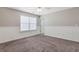 A bright bedroom features neutral walls, plush carpeting, and a ceiling fan for added comfort at 417 Red Coat Ln, Woodstock, GA 30188