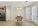 Bright dining area with a chandelier, tile floors, and stainless steel refrigerator at 417 Red Coat Ln, Woodstock, GA 30188