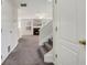 Inviting entryway featuring carpeted stairs and an open view into the living area at 417 Red Coat Ln, Woodstock, GA 30188