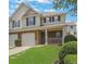 Charming two-story home with a well-manicured lawn, brick accents, and an attached garage at 417 Red Coat Ln, Woodstock, GA 30188