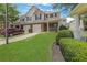 Well-maintained townhome with a garage, manicured lawn, and a neatly paved driveway at 417 Red Coat Ln, Woodstock, GA 30188