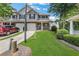 Townhouse with a well-manicured lawn, stepping stones, and a beautiful front porch at 417 Red Coat Ln, Woodstock, GA 30188