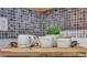 Close-up of kitchen countertop with Rise & Shine, Cream, and Sugar canisters and accent tile backsplash at 417 Red Coat Ln, Woodstock, GA 30188