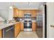Well-appointed kitchen features stainless steel appliances and tile flooring at 417 Red Coat Ln, Woodstock, GA 30188