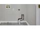 Clean, grey-toned laundry room with grey floors, white trim, and grey walls ready for a washing machine and dryer at 417 Red Coat Ln, Woodstock, GA 30188