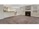 Open-concept living area with a fireplace, connecting to the kitchen and dining space at 417 Red Coat Ln, Woodstock, GA 30188