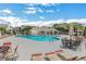 Community pool surrounded by lounge chairs and tables, perfect for relaxing and enjoying the sunny outdoors at 417 Red Coat Ln, Woodstock, GA 30188