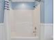 White shower and tub combination features a light blue wall at 417 Red Coat Ln, Woodstock, GA 30188