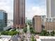 An aerial view captures the vibrant cityscape with impressive high-rise buildings and lush green trees at 620 Peachtree Ne St # 1206, Atlanta, GA 30308