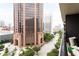 Balcony view highlighting nearby architecture, a street, and outdoor seating with pillows at 620 Peachtree Ne St # 1206, Atlanta, GA 30308