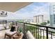 Wide balcony overlooking a vibrant cityscape, complete with comfortable seating and metal railing at 620 Peachtree Ne St # 1206, Atlanta, GA 30308