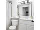 Bright bathroom featuring a white vanity, toilet, and shower with neutral-toned shower curtain at 620 Peachtree Ne St # 1206, Atlanta, GA 30308