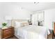 Bright bedroom showcasing a bed with neutral bedding and a view of the bedroom through mirrored closet doors at 620 Peachtree Ne St # 1206, Atlanta, GA 30308