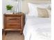 Cozy bedroom decor featuring a neutral-toned nightstand with a lamp and a glimpse of the plush bed at 620 Peachtree Ne St # 1206, Atlanta, GA 30308