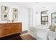 Modern bedroom featuring a wooden dresser, neutral accents, and bright natural light from windows at 620 Peachtree Ne St # 1206, Atlanta, GA 30308