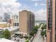 High-rise brick building with a pool, street view, and blue skies in a vibrant city setting at 620 Peachtree Ne St # 1206, Atlanta, GA 30308