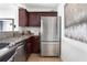 This kitchen features stainless steel appliances, granite countertops, and cherry wood cabinets at 620 Peachtree Ne St # 1206, Atlanta, GA 30308