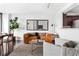Bright living room featuring an orange sofa, neutral rug, and modern decor elements at 620 Peachtree Ne St # 1206, Atlanta, GA 30308