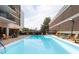 Outdoor pool area with lounge chairs, tables, and umbrellas providing a resort-style experience at 620 Peachtree Ne St # 1206, Atlanta, GA 30308