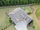 Aerial view of the home showcasing the spacious backyard, mature trees, and well-maintained landscaping at 2385 Saddle Brook Trce, Cumming, GA 30040