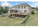 Spacious backyard featuring a deck, covered patio, garden, and landscaped grounds at 2385 Saddle Brook Trce, Cumming, GA 30040