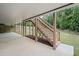View of wooden stairs leading to backyard with covered patio area and lush landscaping at 2385 Saddle Brook Trce, Cumming, GA 30040