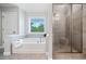 Bathroom featuring a bathtub and a walk-in shower at 2385 Saddle Brook Trce, Cumming, GA 30040