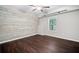 Bedroom with a plank accent wall and wood-look floors at 2385 Saddle Brook Trce, Cumming, GA 30040