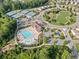 Aerial view of the community clubhouse with swimming pool, tennis courts, and playground at 2385 Saddle Brook Trce, Cumming, GA 30040