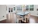 Bright dining area with a modern table, large windows, and access to the backyard at 2385 Saddle Brook Trce, Cumming, GA 30040