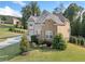 Charming two-story home with brick and stone facade, professionally landscaped front yard, and manicured lawn at 2385 Saddle Brook Trce, Cumming, GA 30040