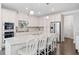 Modern white kitchen featuring granite countertops, stainless steel appliances, and an island with seating at 2385 Saddle Brook Trce, Cumming, GA 30040