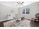 Bright office features a ceiling fan, large window, neutral colors, and wood floors at 2385 Saddle Brook Trce, Cumming, GA 30040
