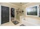 Bathroom with a large window, soaking tub, walk-in shower, and access to a walk-in closet at 271 Double Gate Ct, Sugar Hill, GA 30518
