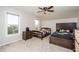 Neutral bedroom with two beds, ceiling fan, and natural light from two windows at 271 Double Gate Ct, Sugar Hill, GA 30518