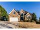 Charming brick home with a well-manicured lawn and attached two car garage at 271 Double Gate Ct, Sugar Hill, GA 30518