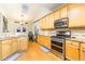 Spacious kitchen with stainless appliances, wooden cabinets, and a dining area with skylight at 271 Double Gate Ct, Sugar Hill, GA 30518