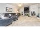 Spacious living room with a large grey couch, fireplace and neutral carpet at 271 Double Gate Ct, Sugar Hill, GA 30518