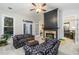 Spacious living room with cozy seating, fireplace, and french doors to the deck at 271 Double Gate Ct, Sugar Hill, GA 30518