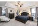 Inviting primary bedroom with tray ceilings, neutral décor and natural lighting at 271 Double Gate Ct, Sugar Hill, GA 30518