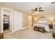 Bedroom with a ceiling fan, walk-in closet, and a bench at the foot of the bed at 271 Double Gate Ct, Sugar Hill, GA 30518