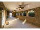 Covered brick patio with ceiling fans and arched openings offers an inviting outdoor space at 271 Double Gate Ct, Sugar Hill, GA 30518