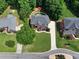 Aerial view of neighborhood home featuring manicured lawns and mature trees at 2725 Bailey Ne Pl, Conyers, GA 30013