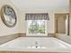 Luxurious bathroom featuring a large soaking tub, perfect for relaxation and unwinding after a long day at 2725 Bailey Ne Pl, Conyers, GA 30013