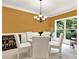 Inviting dining room featuring a stylish chandelier, comfortable seating, and large window offering natural light at 2725 Bailey Ne Pl, Conyers, GA 30013