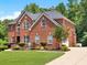 Beautiful two-story brick home with a well-manicured lawn and mature landscaping at 2725 Bailey Ne Pl, Conyers, GA 30013