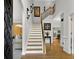 Grand foyer with hardwood floors, staircase, and elegant decor with views of the front door and living room at 2725 Bailey Ne Pl, Conyers, GA 30013