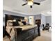 Comfortable bedroom with a tray ceiling, ceiling fan, a cozy fireplace, and a neutral color palette at 2725 Bailey Ne Pl, Conyers, GA 30013