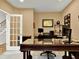 Well-lit home office with a large desk, complemented by a stylish chair and natural light from the exterior at 2725 Bailey Ne Pl, Conyers, GA 30013