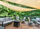 Inviting outdoor patio featuring comfortable seating, fire pit, and shade sails for relaxing and entertaining at 2725 Bailey Ne Pl, Conyers, GA 30013
